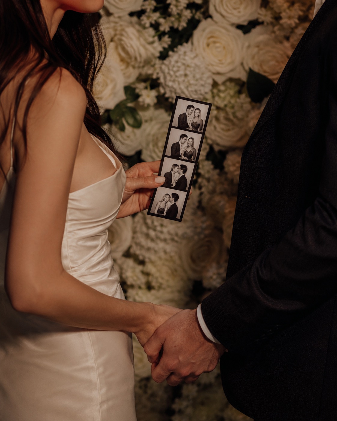 An engaged couple posing at the booth